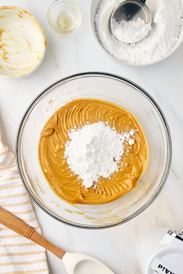 overhead view of confectioners' sugar added to peanut butter mixture for buckeyes