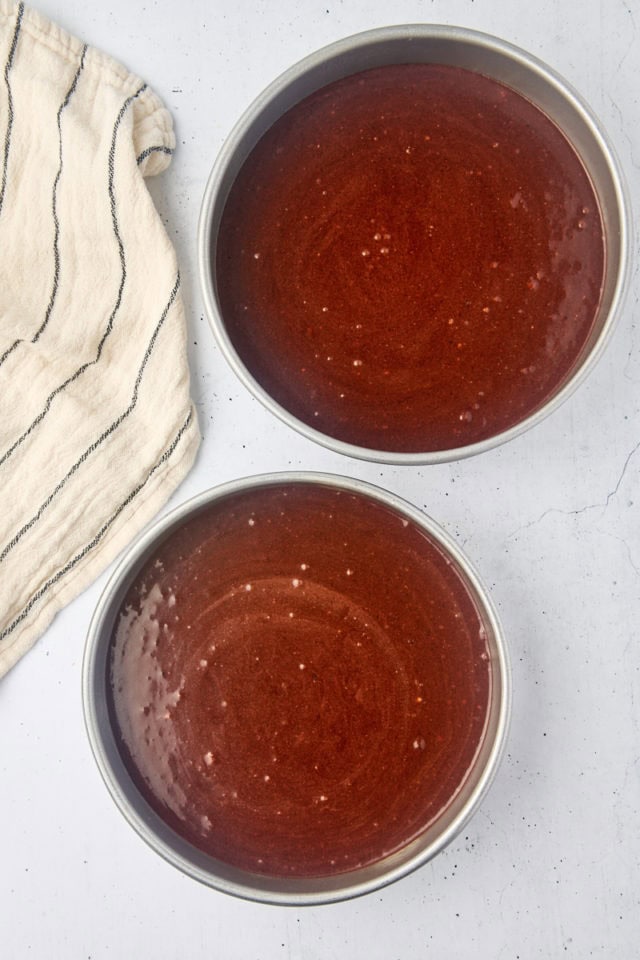 overhead view of mahogany cake batter in two round cake pans