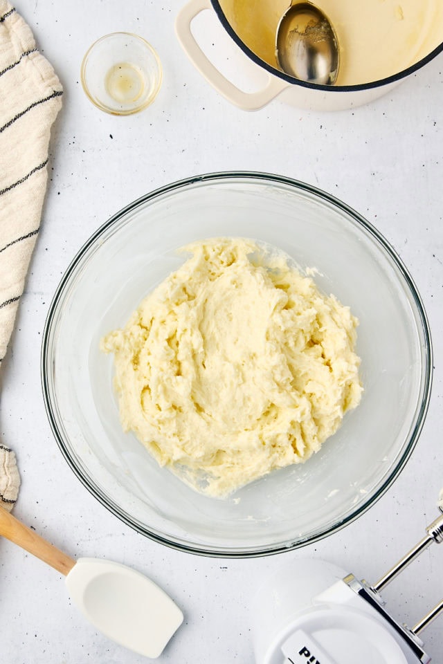 overhead view of ermine frosting in a glass mixing bowl