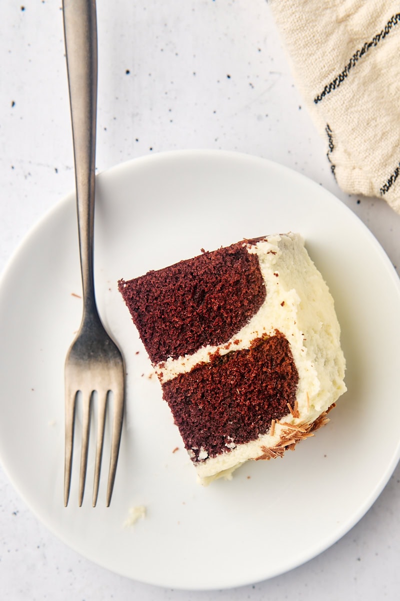 a partial slice of mahogany cake on a white plate with a fork