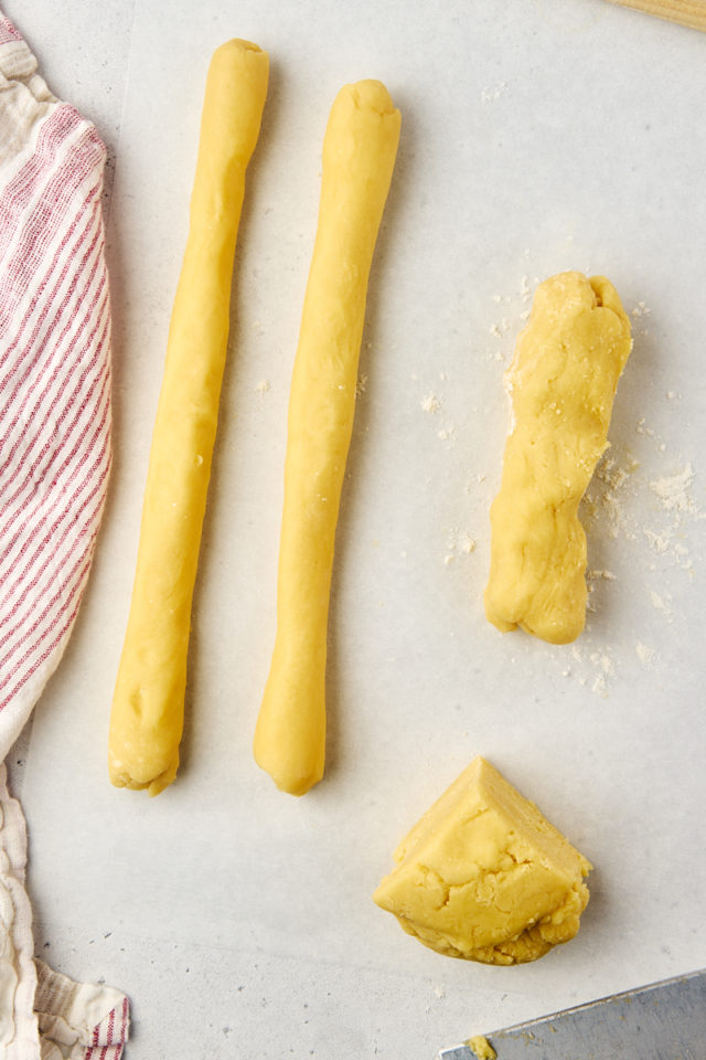 overhead view of raspberry ribbon cookie dough being shaped into logs