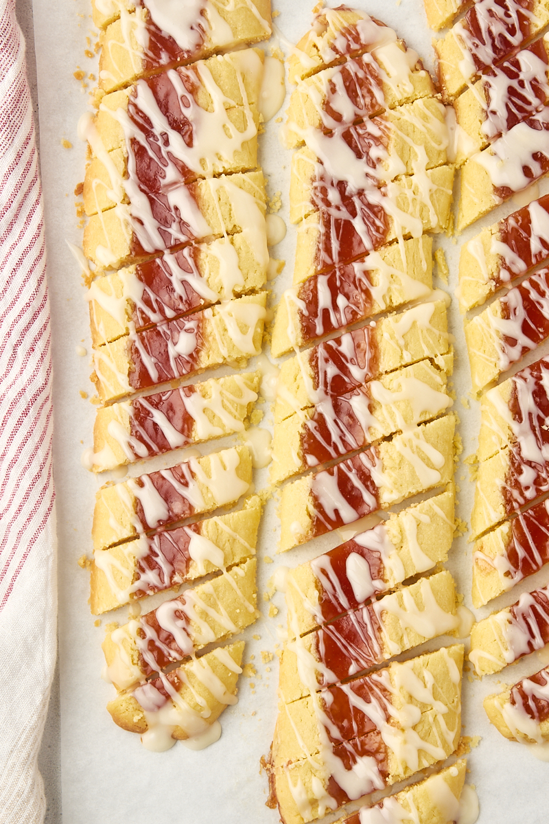 overhead view of sliced and glazed raspberry ribbon cookies