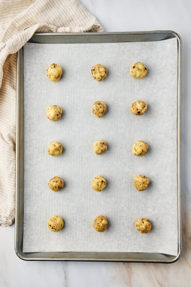 overhead view of snowball cookies on a baking sheet ready to go into the oven