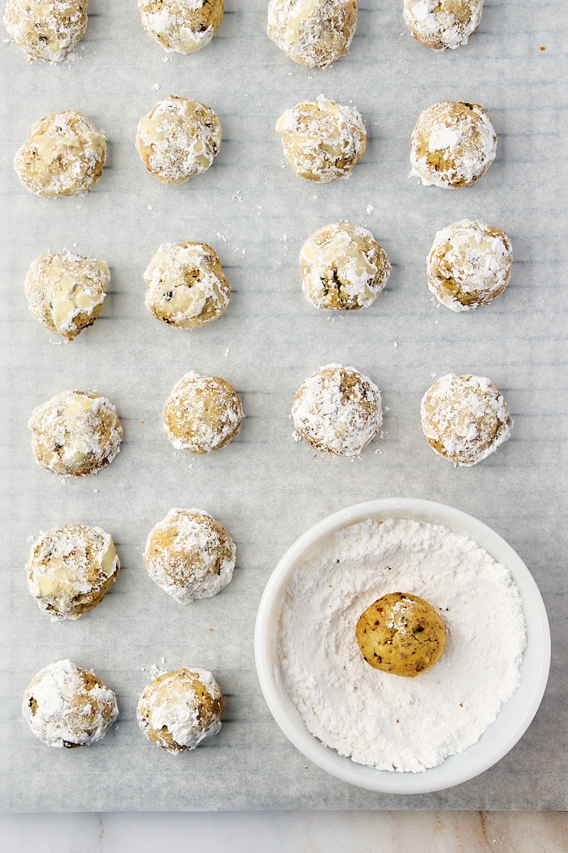 overhead view of snowball cookies rolled in powdered sugar