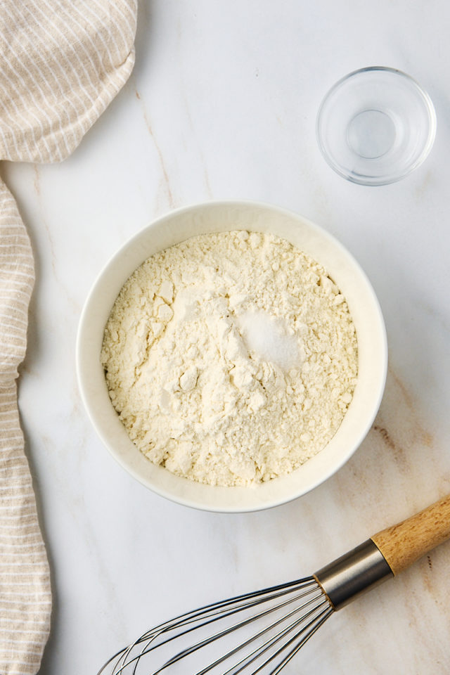 overhead view of flour and salt in a mixing bowl