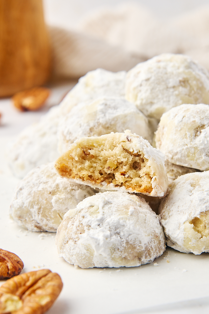 several snowball cookies along with another cookie with a bite missing