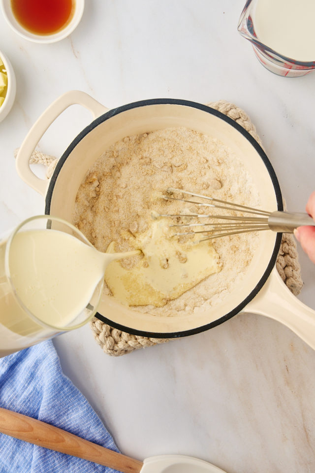 overhead view of cream being added to sugar mixture for sugar cream pie