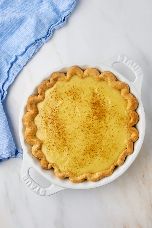 overhead view of sugar cream pie with cinnamon sprinkled over the top