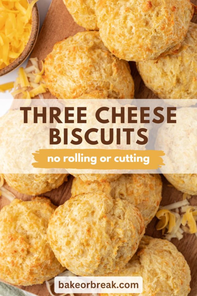 overhead view of three cheese biscuits on a wooden cutting board; text overlay "three cheese biscuits no rolling or cutting"