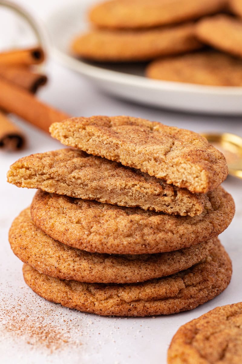 stack of three brown butter snickerdoodles with two cookie halves on top