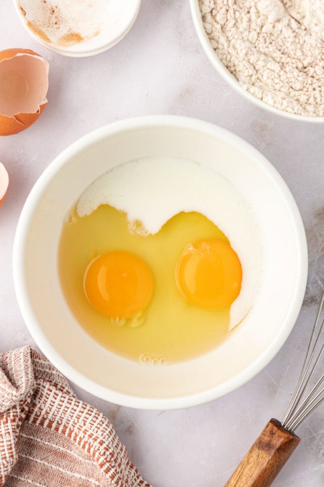 overhead view of eggs and milk in a mixing bowl