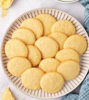 overhead view of cornmeal cookies on a large white plate