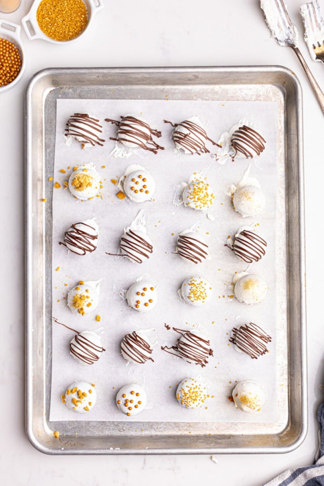 overhead view of freshly-dipped gingerbread truffles on a baking sheet