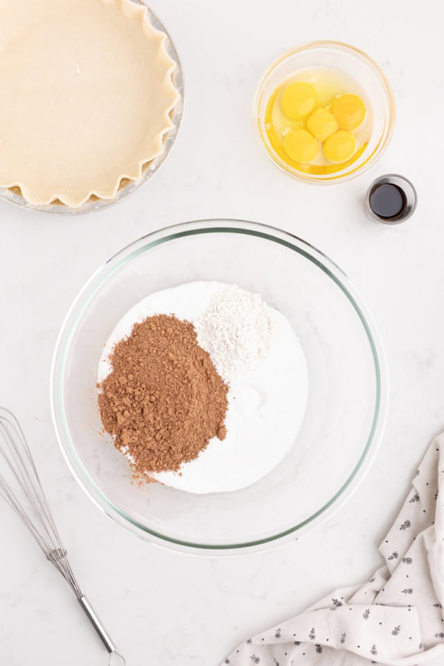 overhead view of sugar, cocoa powder, flour, and salt in a mixing bowl