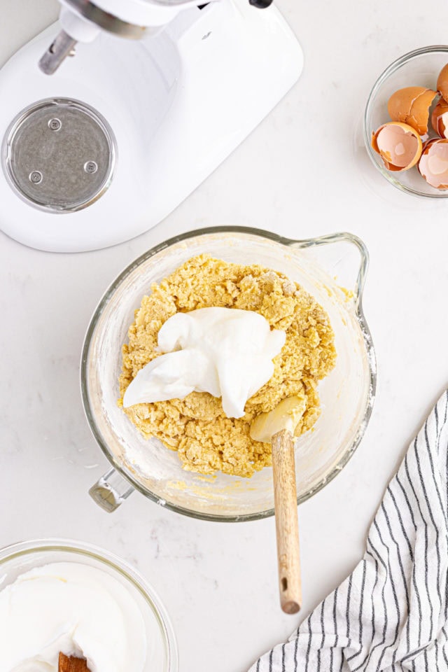 overhead view of whipped egg whites added to Italian rainbow cookie dough