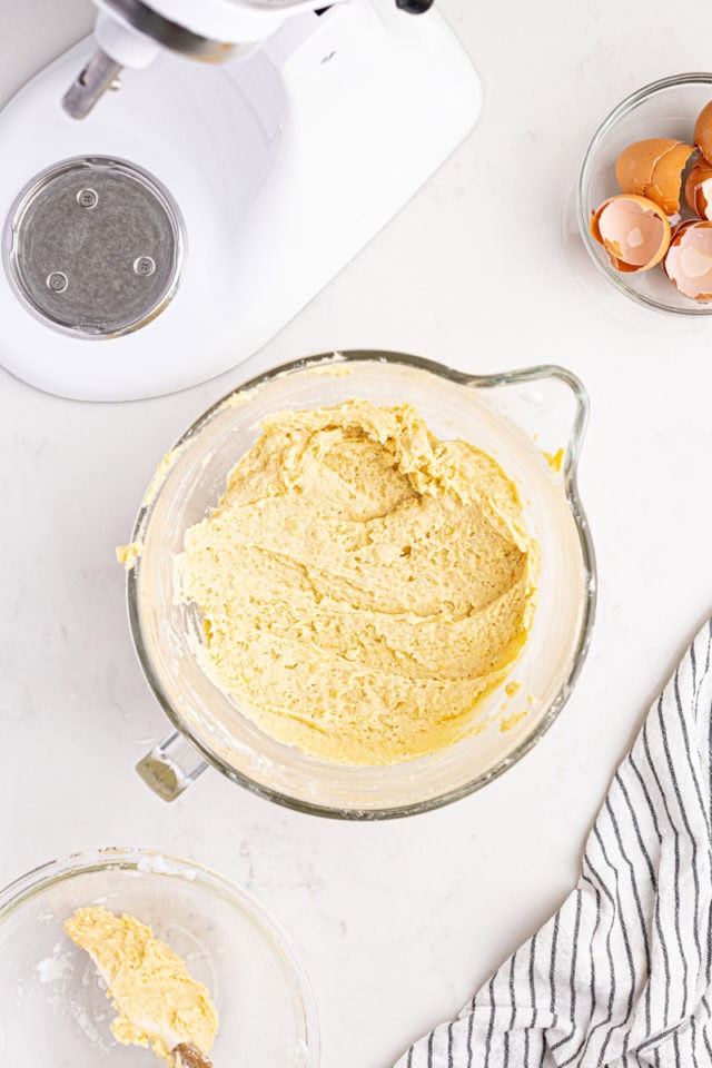 overhead view of mixed Italian rainbow cookie dough in a glass mixing bowl