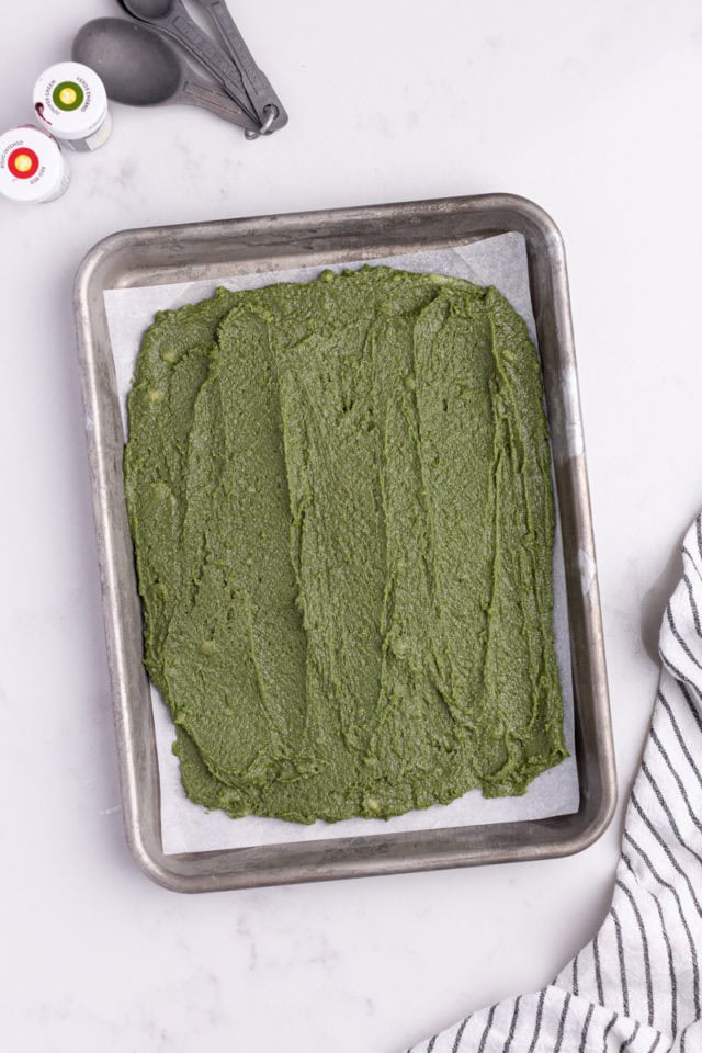 overhead view of green dough spread in a baking pan