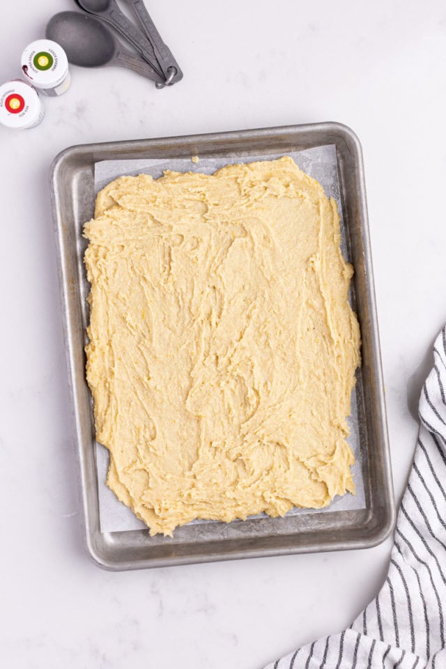 overhead view of untinted Italian rainbow cookie dough spread in a baking pan