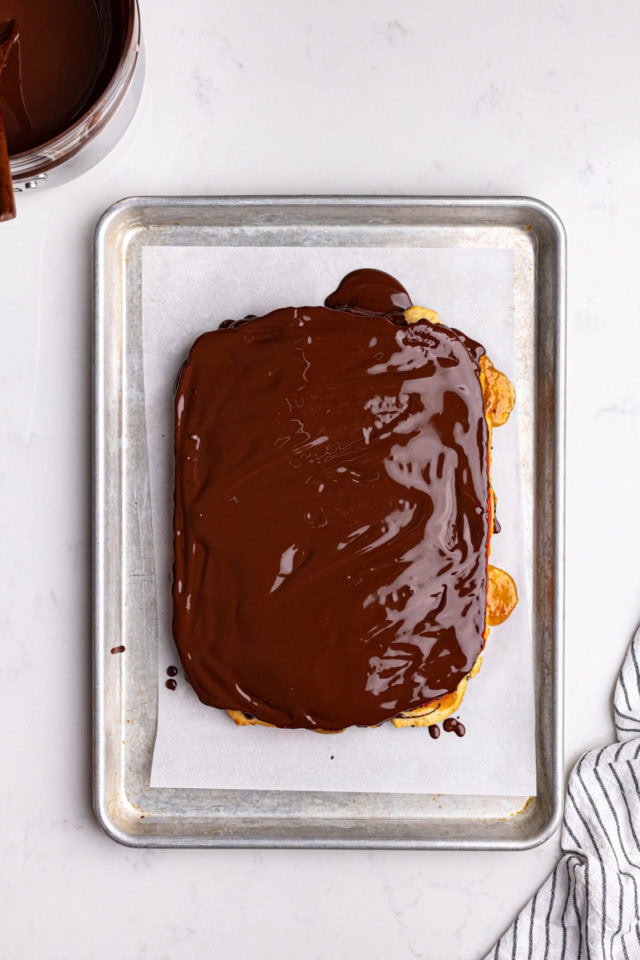 overhead view of chocolate spread over Italian rainbow cookies