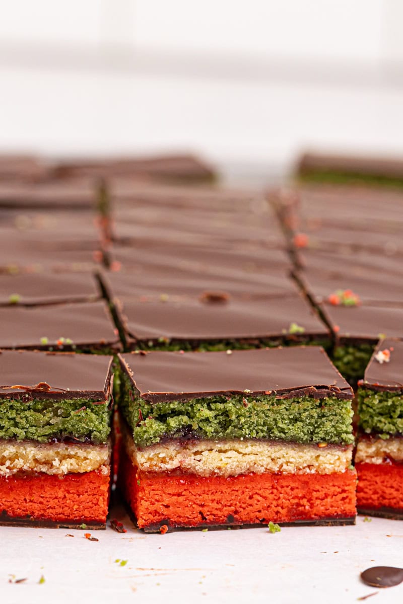 several Italian rainbow cookies on parchment paper