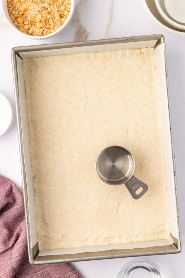 overhead view of macadamia shortbread dough pressed into a baking pan