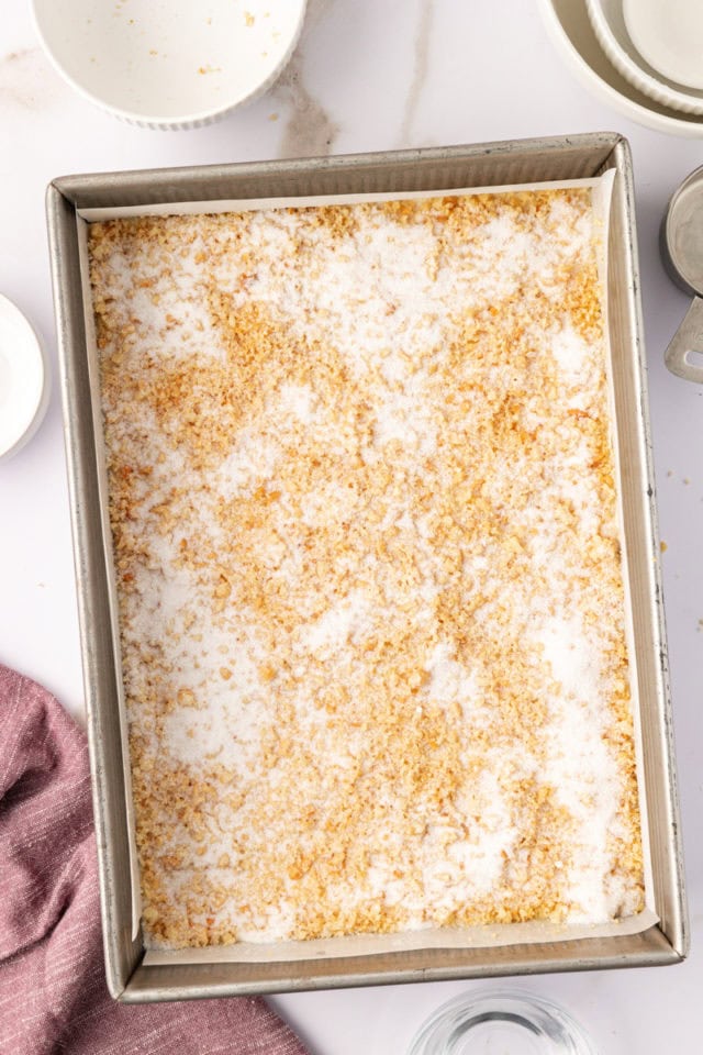 sugar sprinkled over macadamia shortbread in a baking pan