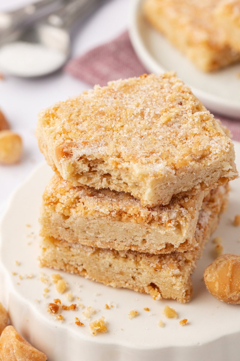 stack of three macadamia shortbread with a bite missing from the top cookie