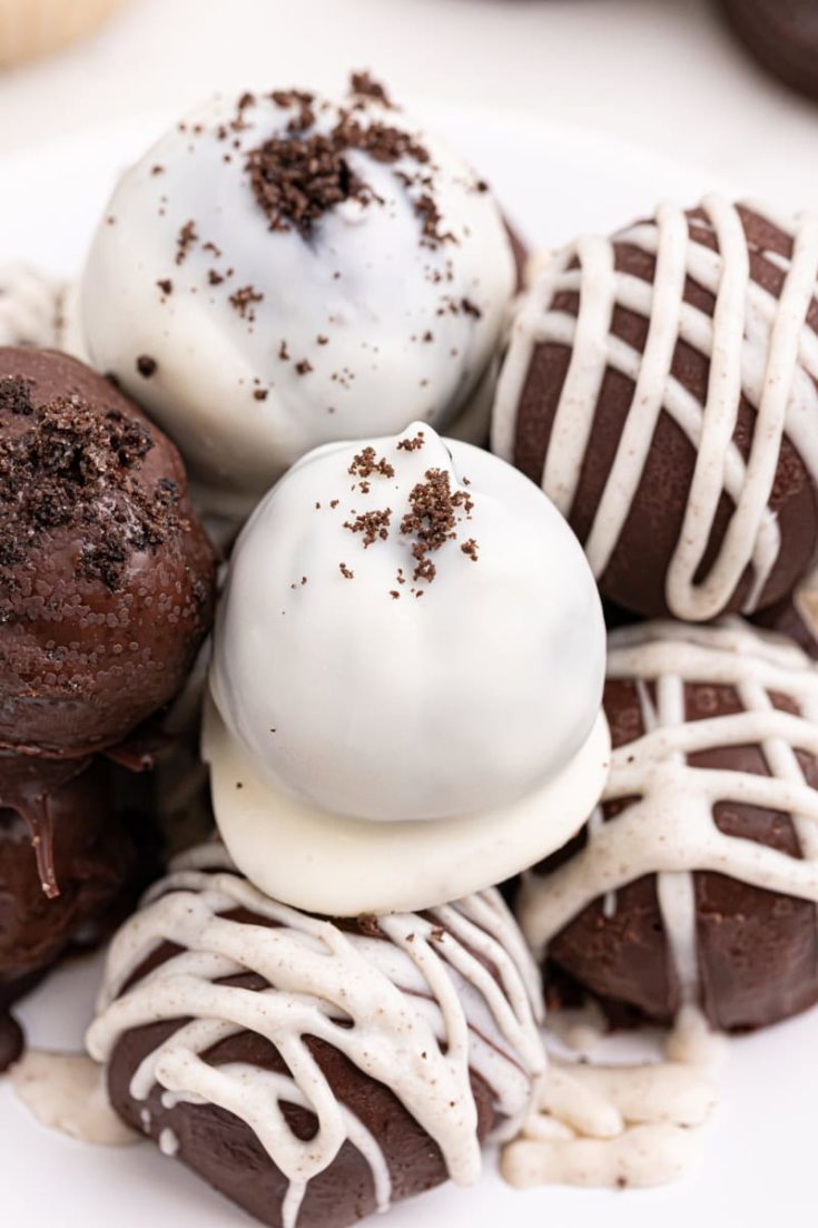 several Oreo truffles on a white plate