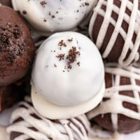 several Oreo truffles on a white plate