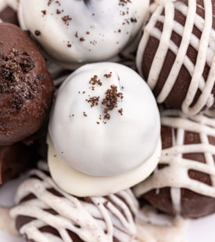 several Oreo truffles on a white plate