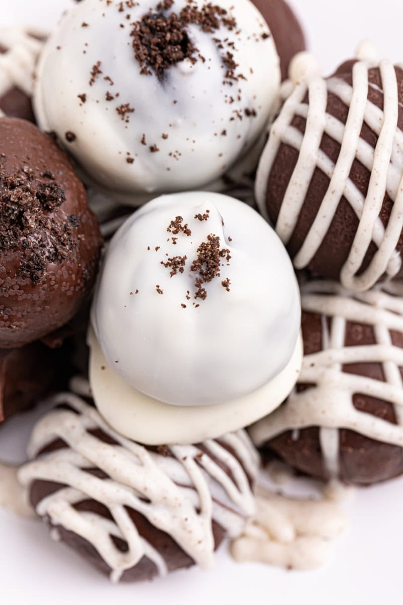 several Oreo truffles on a white plate