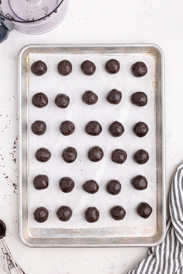 overhead view of Oreo truffle mixture formed into balls on a baking sheet