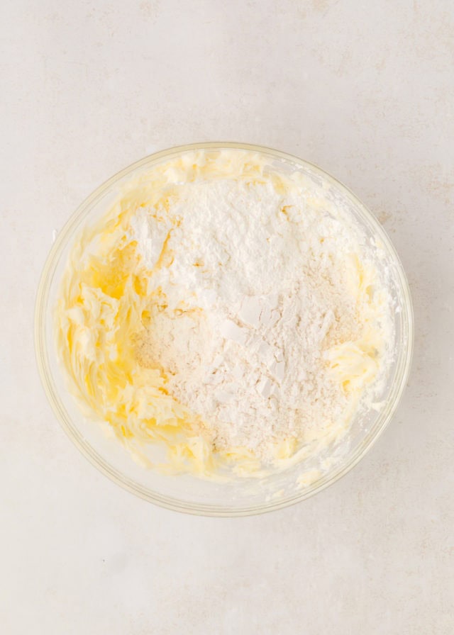 overhead view of flour and cornstarch added to creamed butter and sugar