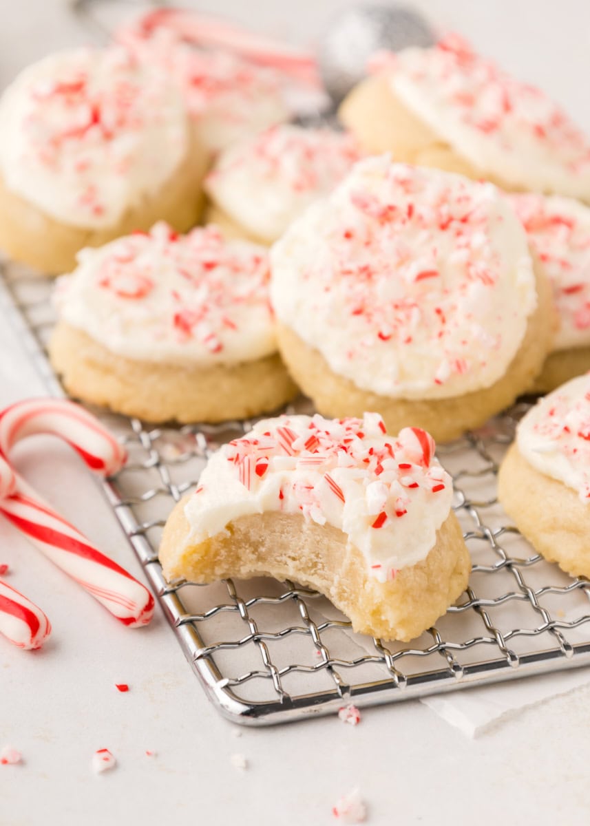 peppermint meltaways on a wire rack with a bite missing from the cookie in front