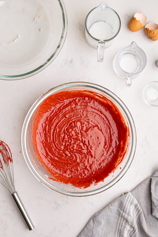 overhead view of red velvet cake batter in a mixing bowl