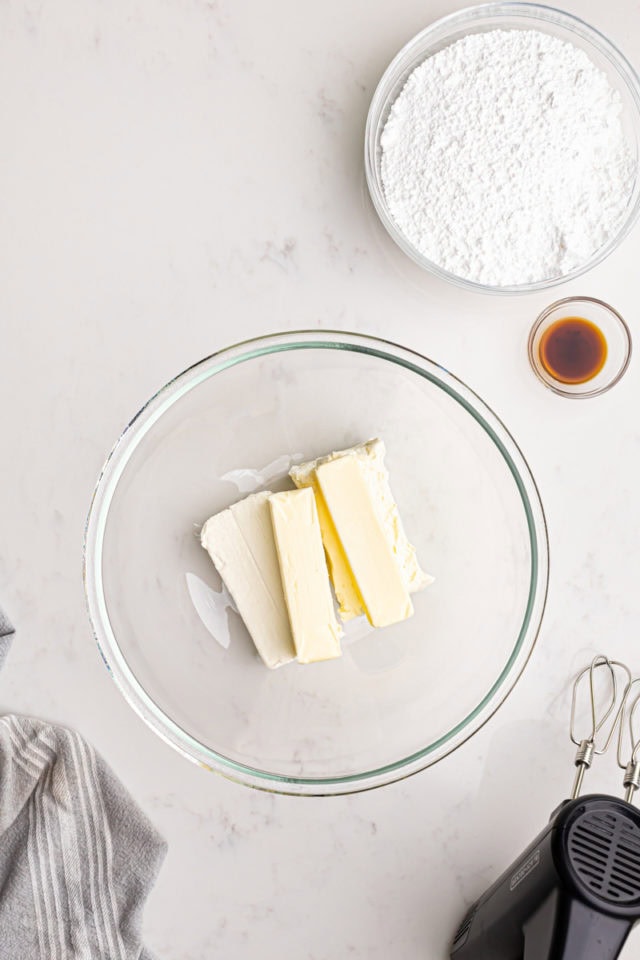 overhead view of butter and cream cheese in a mixing bowl