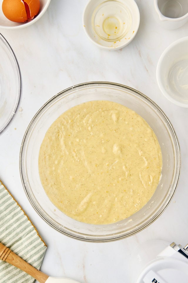 overhead view of mixed cardamom cake batter in a glass mixing bowl