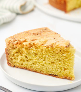 a slice of cardamom cake on a white plate