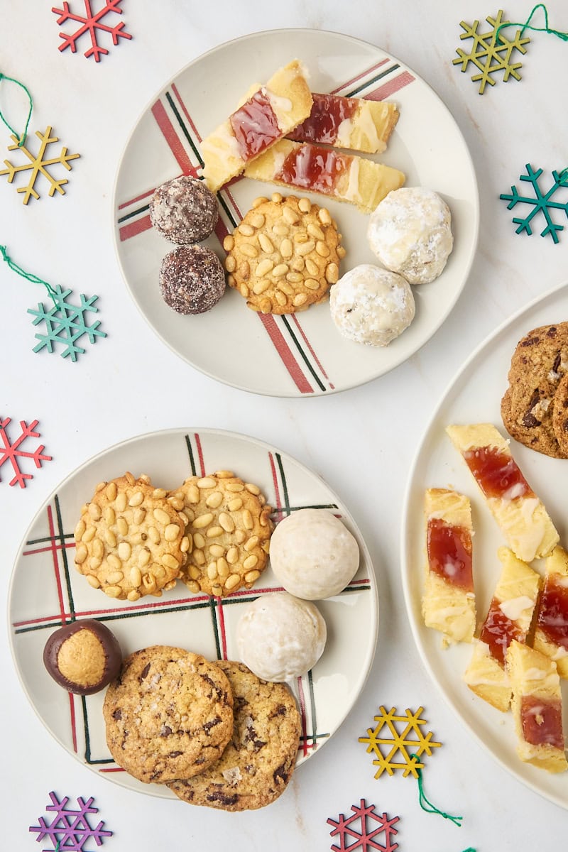 overhead view of various Christmas cookies and treats on two small plates