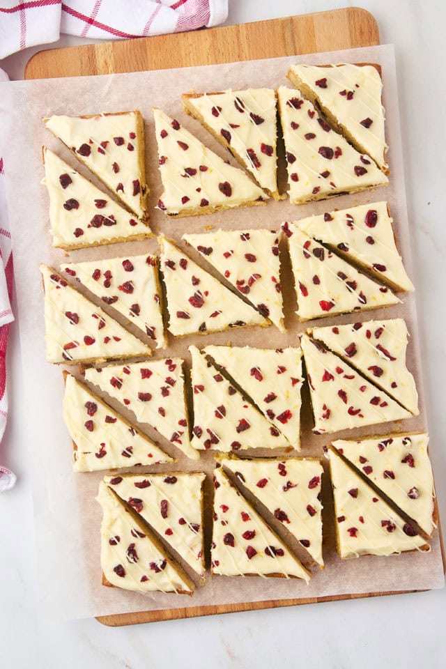 overhead view of sliced cranberry bliss bars on parchment paper