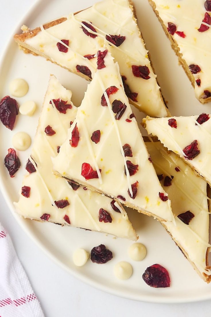 overhead view of several cranberry bliss bars on a white plate