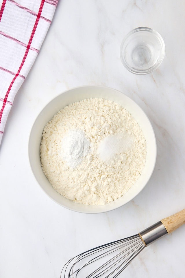 overhead view of flour, baking powder, and salt in a bowl