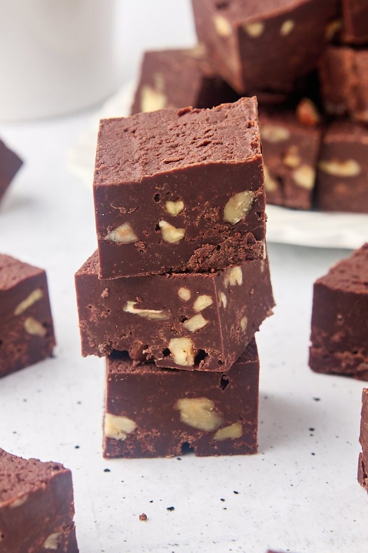 stack of three pieces of fudge surrounded by more fudge