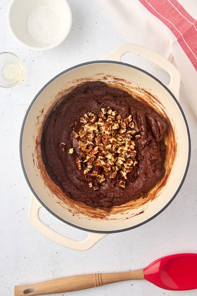 overhead view of nuts and vanilla added to fudge mixture