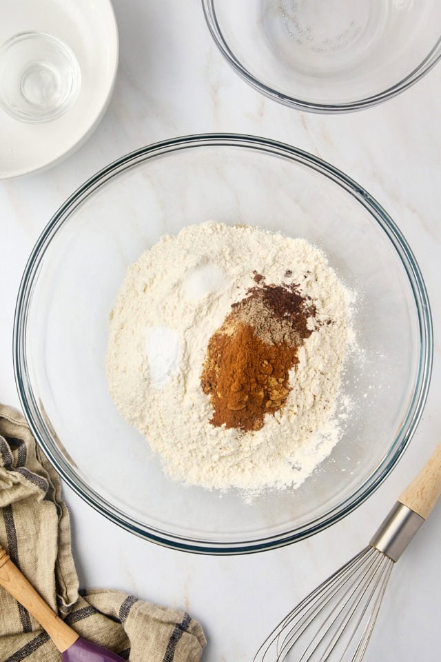 overhead view of flour, baking soda, salt, and spices in a mixing bowl