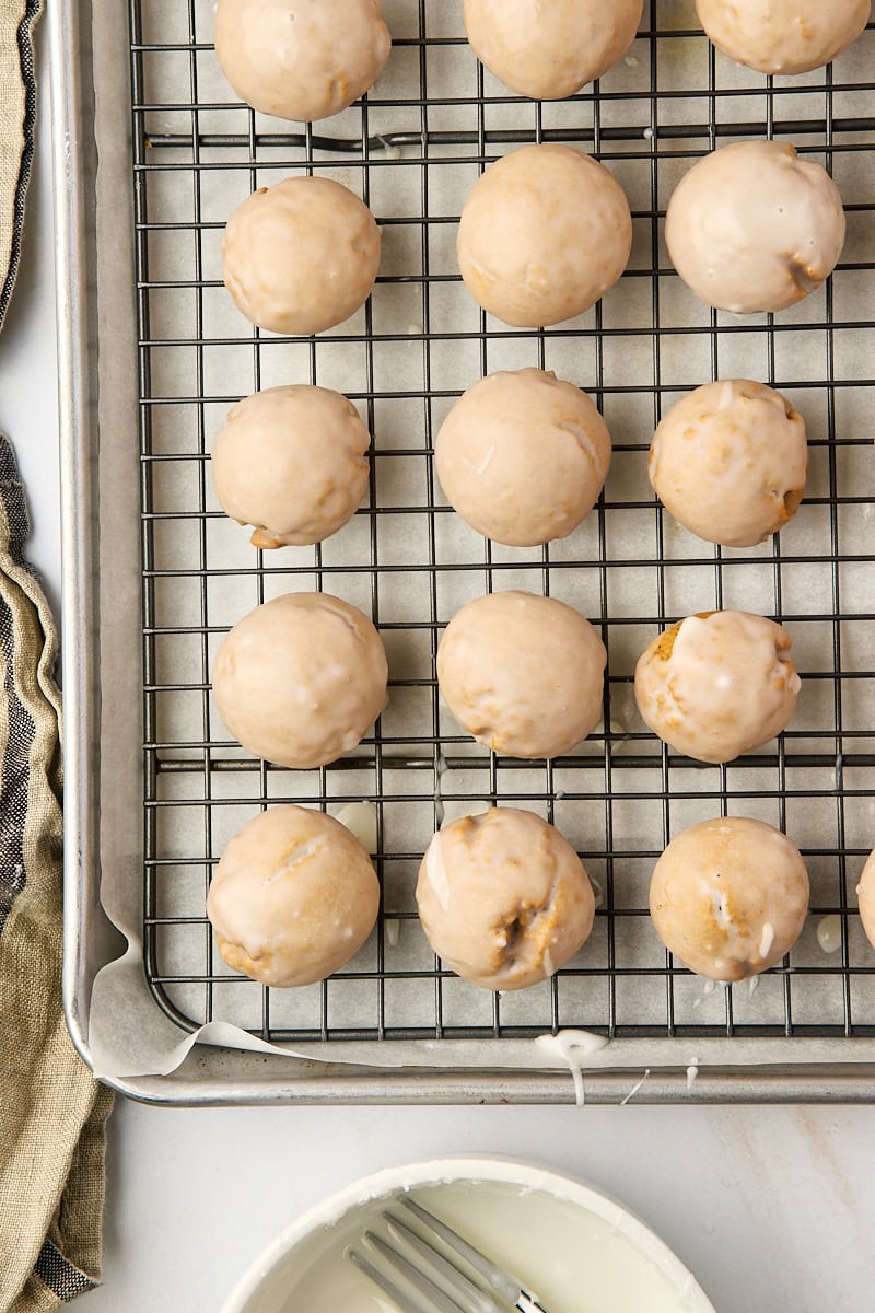 overhead view of glazed Pfeffernüsse cookies on a wire rack