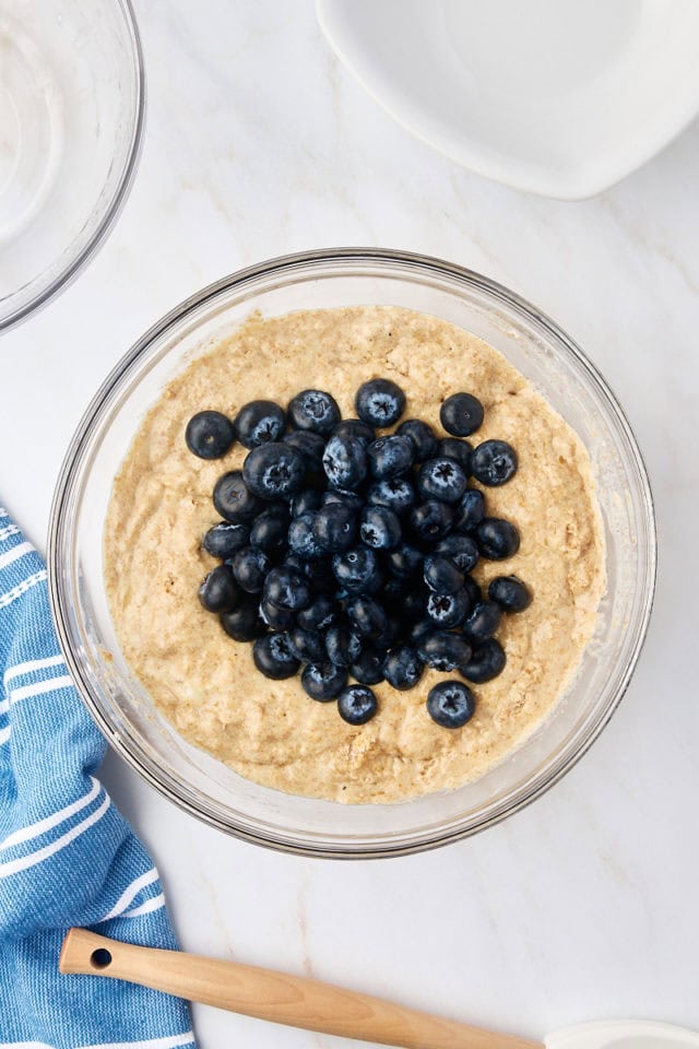 overhead view of blueberries added to muffin batter