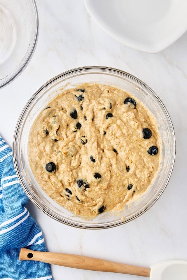 overhead view of whole wheat blueberry muffin batter in a mixing bowl