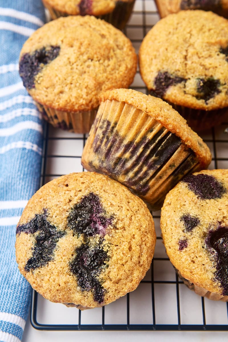 whole wheat blueberry muffins on a wire cooling rack