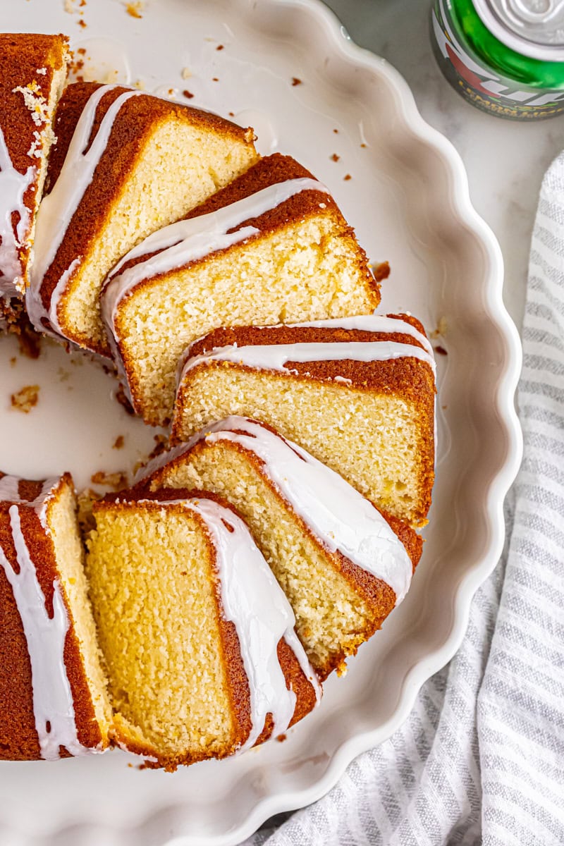 overhead view of sliced 7UP cake on a white cake plate